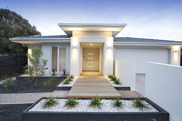 Modern landscaping with white contemporary home.