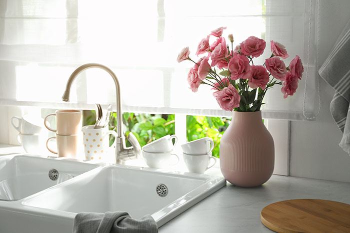 Spring kitchen with pink vase of flowers.