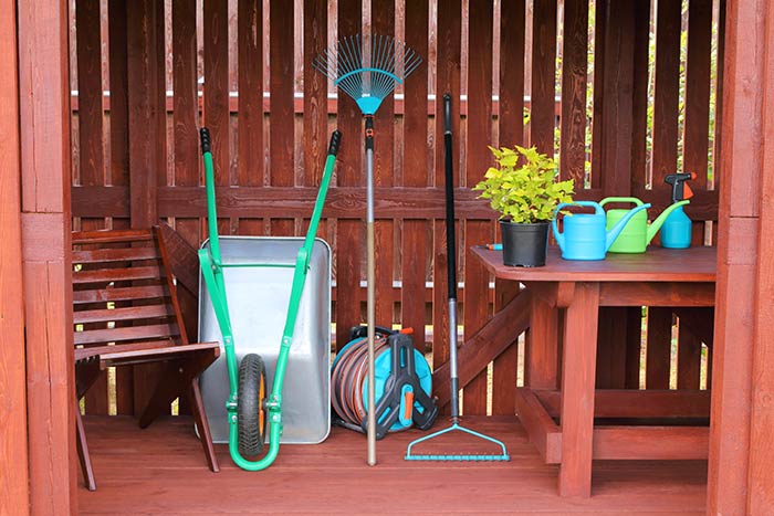 Outdoor tool shed with gardening tools.