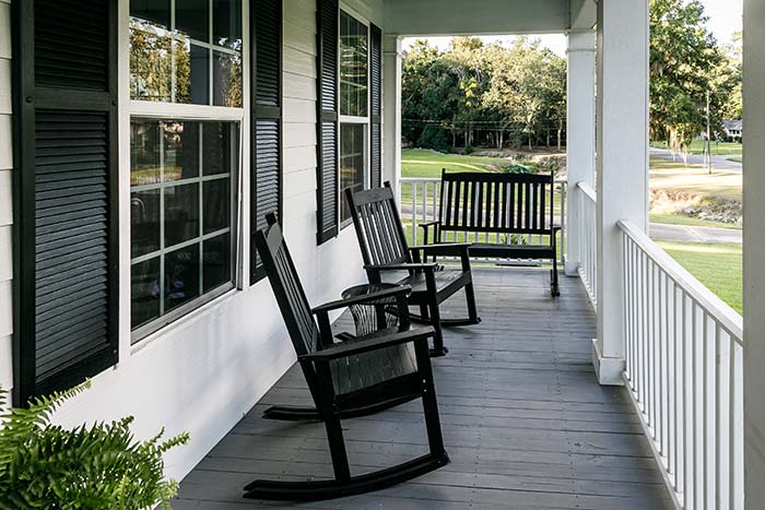 Front porch with black rocking chairs.