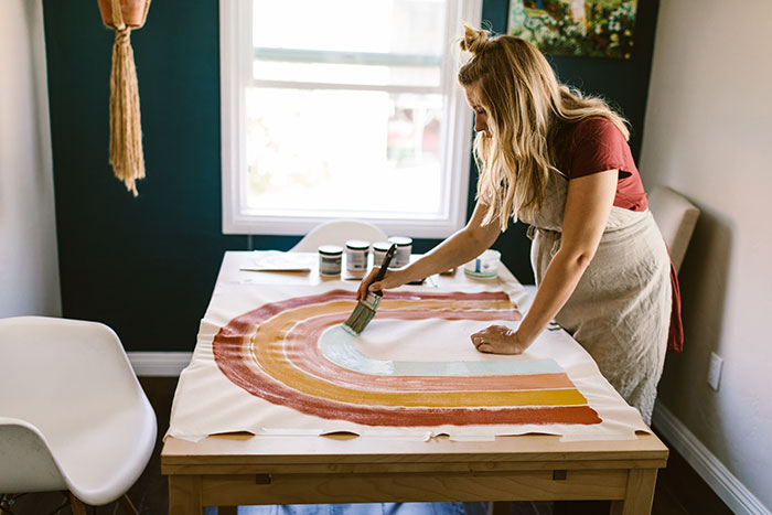 https://www.schlage.com/content/dam/sch-us/blog/post-images/2021/06-june/pregnant-woman-painting-rainbow-on-canvas.jpg