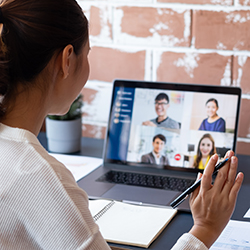 Woman in virtual meeting while working from home.