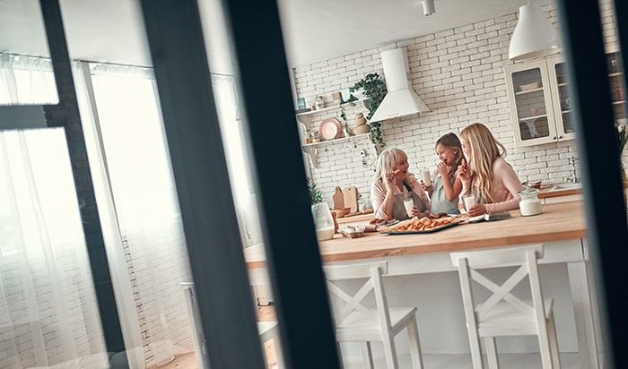 Daughter, mother and grandmother on kitchen