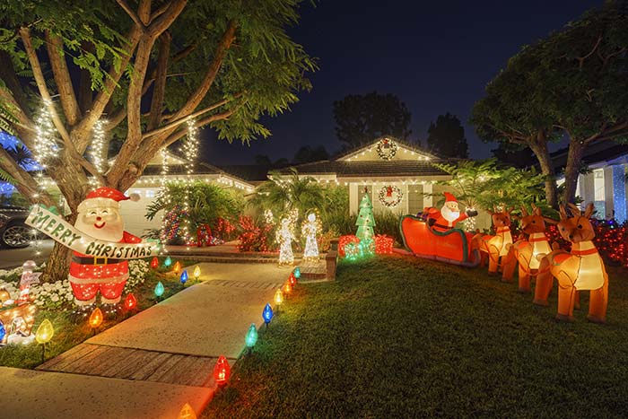 Festive home with Christmas lights and blow up santa with reindeer.