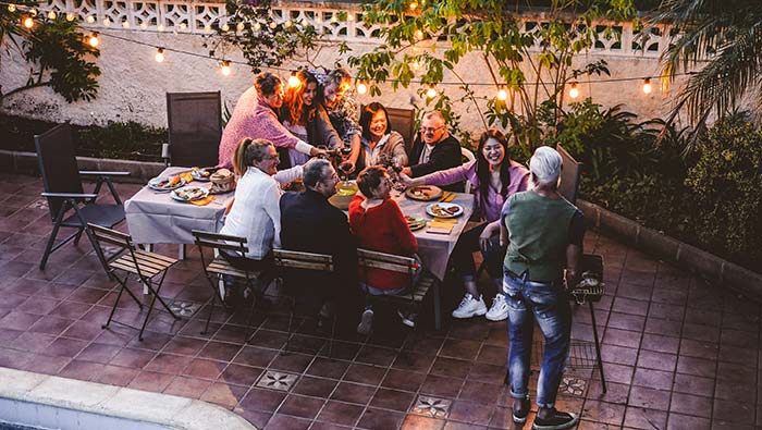 Group of friends enjoying outdoor dinner party.