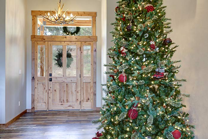 Christmas tree in entryway of mountain home.