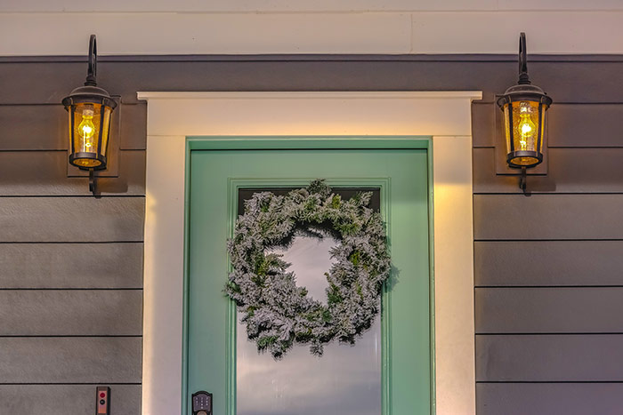 Mint colored front door with winter wreath.