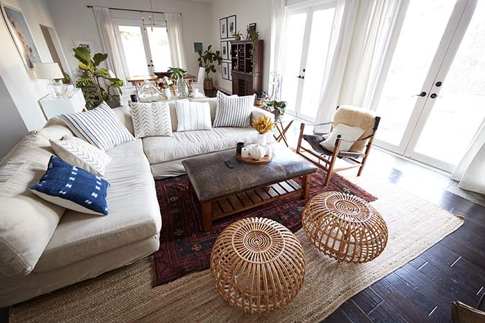 Bohemian style living room with two rattan ottomans.