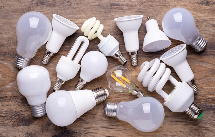 Different kinds of light bulbs on wooden background