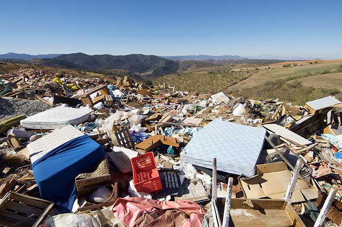 Landfill with mattresses and other large household items.