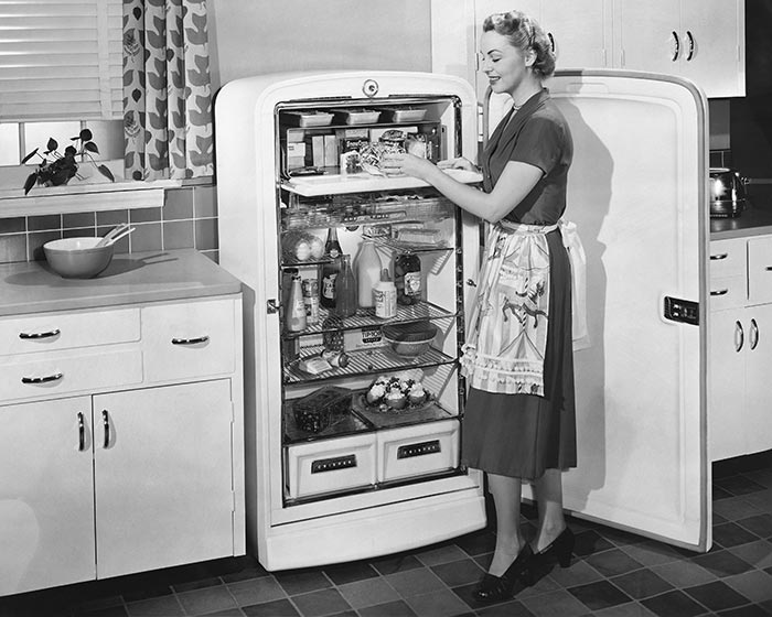 Woman with open refrigerator.