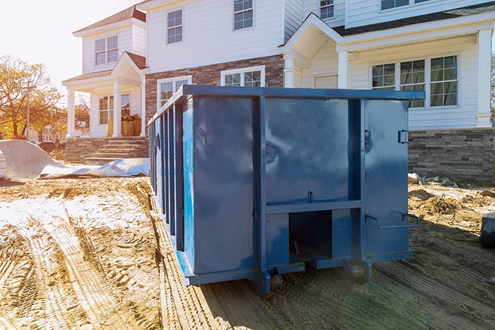 New home build with dumpster for material waste.