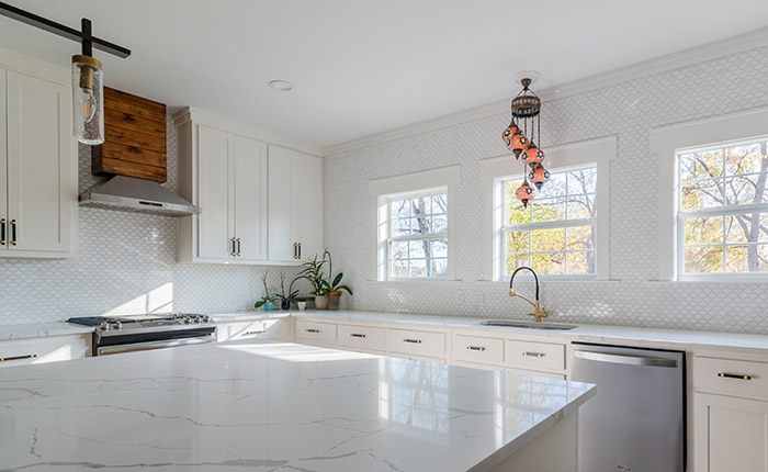 White kitchen with black and gold finishes and hardware.