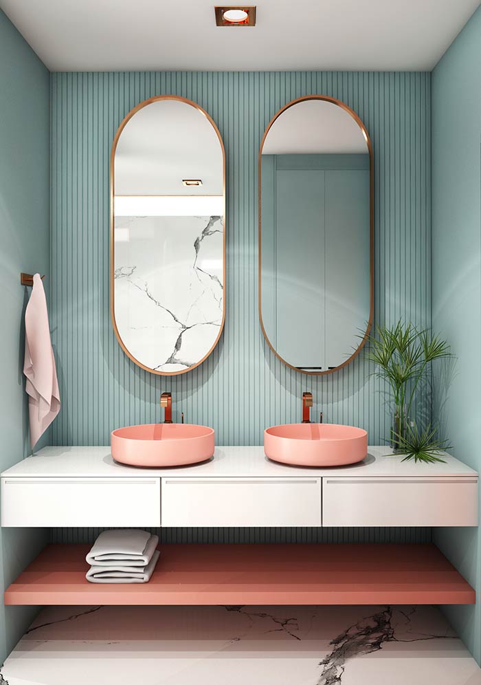 Modern blue bathroom with pill shaped mirrors.