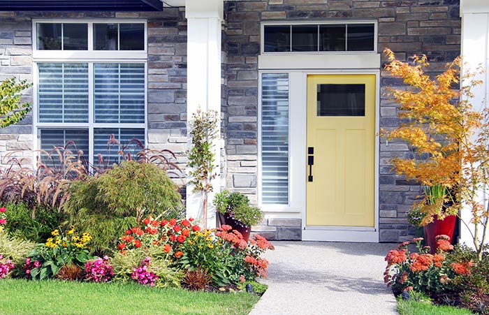 https://www.schlage.com/content/dam/sch-us/blog/post-images/2023/02-february/suburban-stone-home-with-bright-yellow-front-door-and-black-front-door-handle.jpg