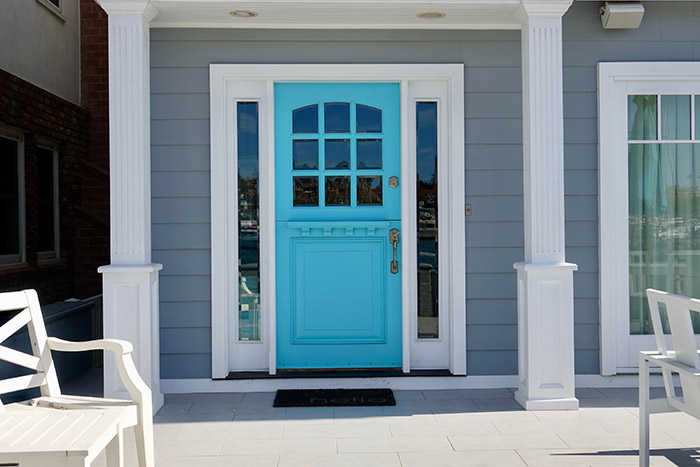Bright blue dutch door on blue beach house.