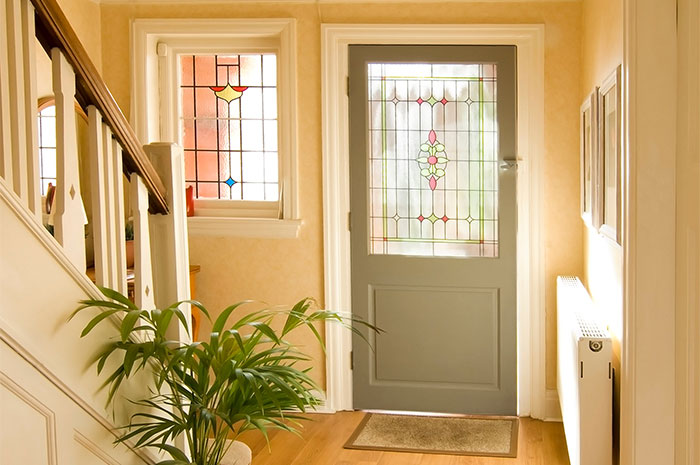 Entryway with stained glass front door.
