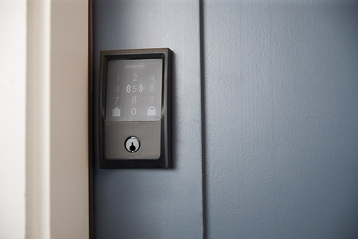 Schlage Encode Plus Smart WiFi Deadbolt in matte black with Century trim on front door.