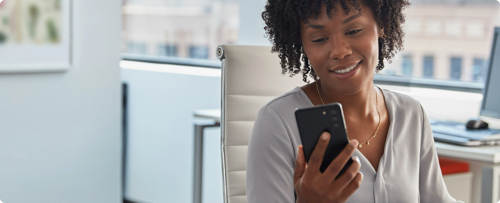 Person looking at their cell phone with releief.