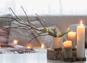 Minimalist holiday decor with candles and greenery.