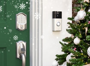 Schlage Encode wifi smart lock and Ring video doorbell on green front door next to Christmas tree.
