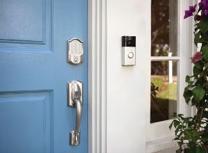 Schlage Encode wifi smart lock and Ring video doorbell on blue front door.