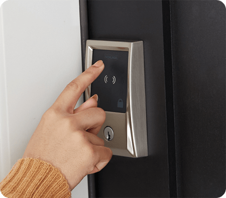 Woman using touchscreen to unlock Schlage Encode Plus WiFi smart lock