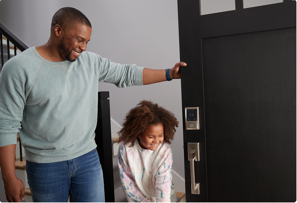 Dad opening door for child.