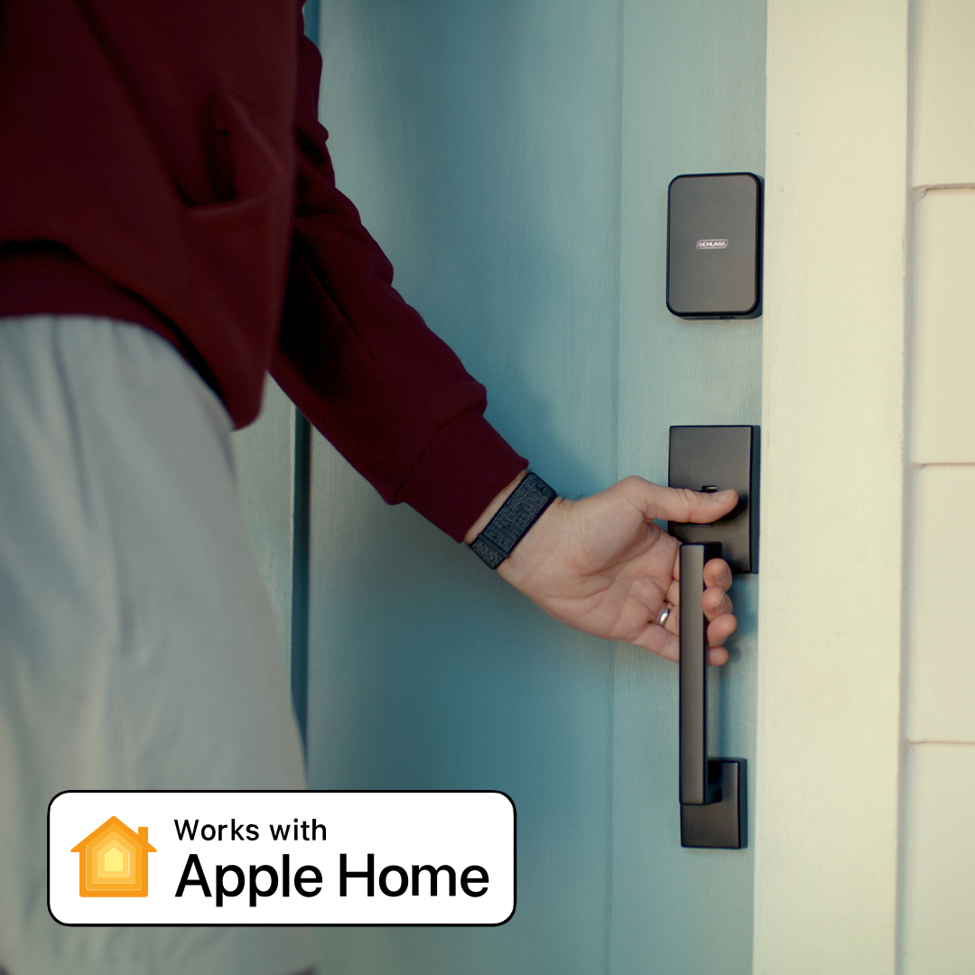 Man enters home with Schlage Sense Pro Apple home key smart lock with UWB to unlock door with Apple watch