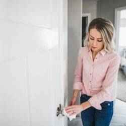 Woman cleaning door knob