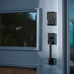 schlage encode smart wifi deadbolt and century handleset on blue front door 