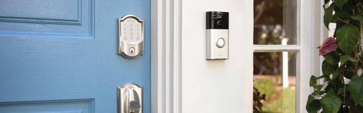 Schlage Encode wifi smart lock and Ring video doorbell on blue front door.