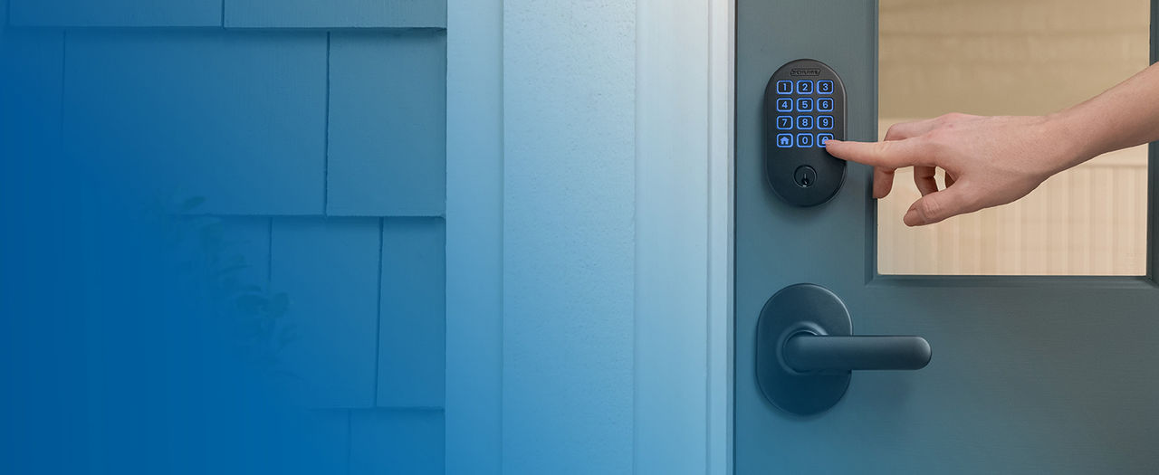 Person's finger using one-touch locking button on exterior keypad of matte black Schlage Arrive Smart lock