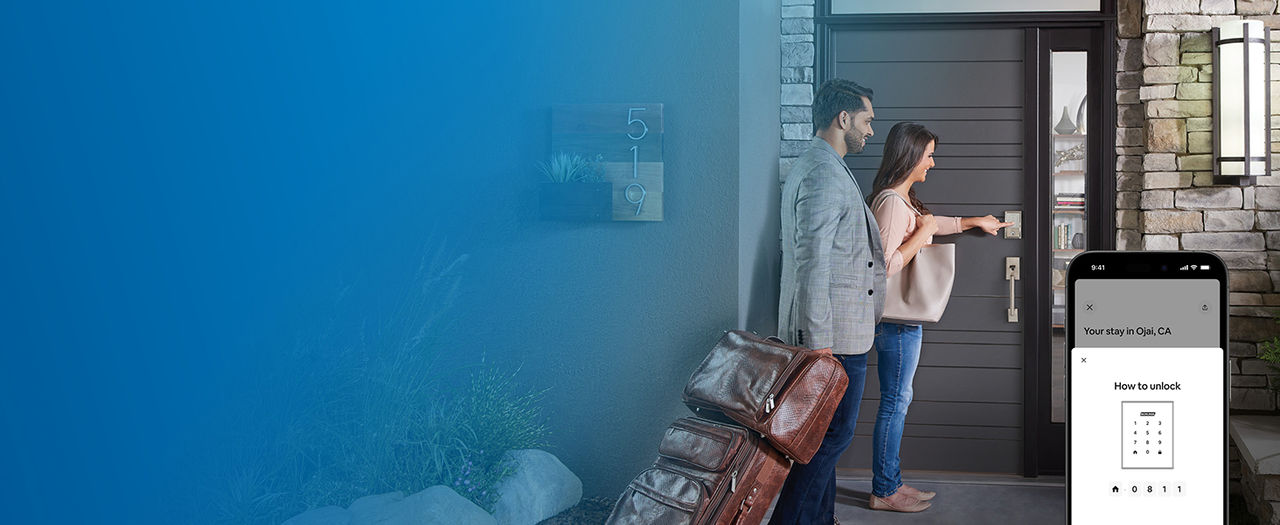 Woman and man with travel bags enter access code on touchscreen of Schlage Encode Smart Lock and overlay of Airbnb app interface 