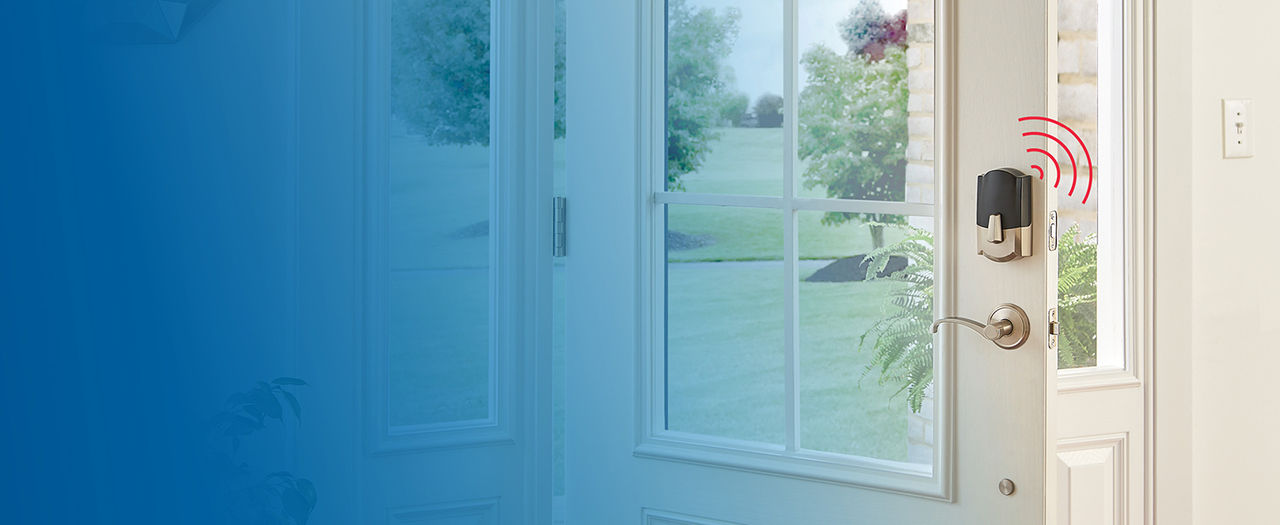 Interior side of Satin Nickel Schlage Encode Plus Smart Lock installed on open door with red wifi symbol lines coming off lock